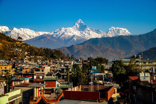 View of the snow covered peak of Annapurna with village in the foreground, Nepal