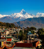 View of the snow covered peak of Annapurna with village in the foreground, Nepal