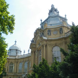 Yellow public bath house building with ornate decorations and multiple statues