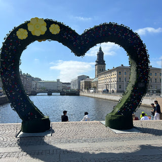 View through a green heart outline with the canal and cathedral withing the heart
