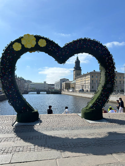 View through a green heart outline with the canal and cathedral withing the heart