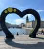 View through a green heart outline with the canal and cathedral withing the heart
