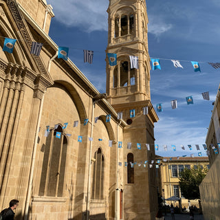 Sacred Temple of Virgin Mary with tower and Greek flags. Nicosia, Cyprus