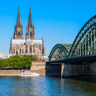 Cologne Cathedral and Hohenzollern Bridge through Rhine river in Cologne, Germany