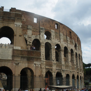 The Colosseum, Rome. An elliptical structure made of stone standing four stories tall and capable of holding up to 50,000 spectators