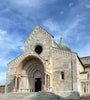 White stone facade of Cathedral of St. Cyriacus in Ancona Italy. The entrance is formed of a round arch with 4 columns