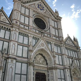 Neo-gothic facade of Florence Cathedral a blend of white, green, and red marble, adorned with statues