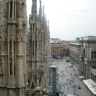 View from the roof of Milan Cathedral with gothic spires and the piazza below