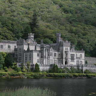 Kylemore Abbey surrounded by lush greenery and a body of water, Ireland