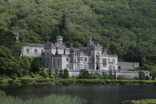 Kylemore Abbey surrounded by lush greenery and a body of water, Ireland