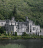 Kylemore Abbey surrounded by lush greenery and a body of water, Ireland