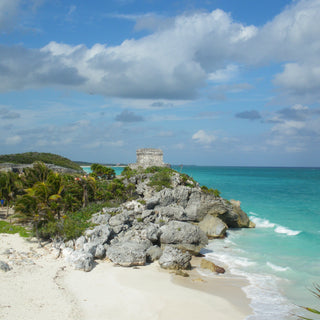 Coastline, bright blue sea and Mayan ruins at Tulum Mexico