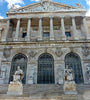 National Library of Spain in Madrid. A grand, neoclassical building featuring a prominent exterior staircase and a Corinthian portico
