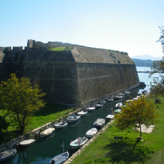Naval defence wall and canal with small boats, Corfu, Greece 