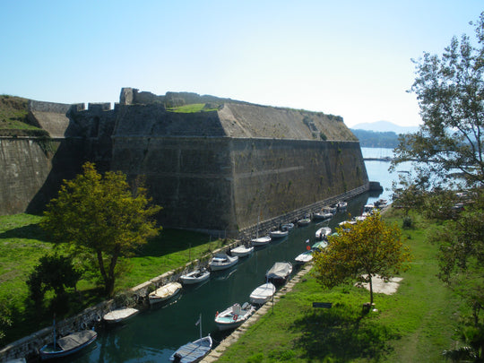 Naval defence wall and canal with small boats, Corfu, Greece 