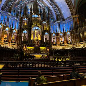 Notre-Dame Basilica of Montreal interior with ornate decor featuring blues, azures, reds, purples, silver and gold, with intricate wooden carvings