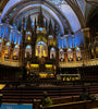 Notre-Dame Basilica of Montreal interior with ornate decor featuring blues, azures, reds, purples, silver and gold, with intricate wooden carvings