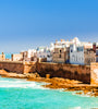 View of the old city of Essaouira in Morocco with red coastal wall and ramparts