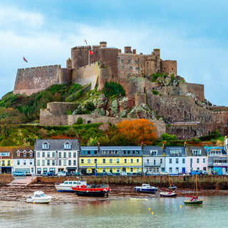 Mount Orgueil castle over the Gorey village promenade with yachts on the shore, Saint Martin, bailiwick of Jersey, Channel Islands