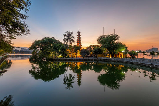 Pagoda lit up ay sunset and reflected in a calm lake