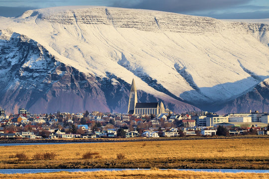 View of Reykjavik and Church of Hallgrímur with snowy mountain background
