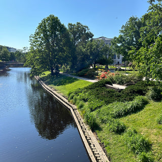 Riga canal and surrounding park on a beautiful summer day with bright blue sky