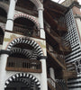 Wooden staircase of Rila Monastery and walls and arches decorated with black and white tiles. Bulgaria