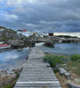 Wooden jetty in cove with small boats on Vrångö island, Sweden 
